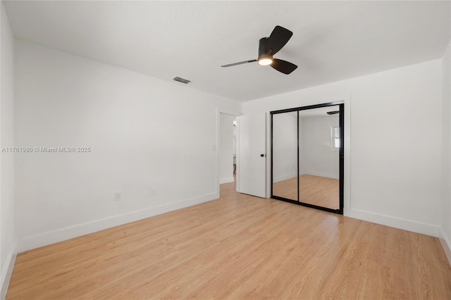 spare room featuring baseboards, visible vents, and light wood finished floors