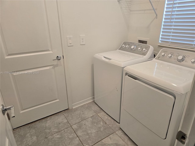 laundry room with washing machine and clothes dryer, laundry area, and baseboards