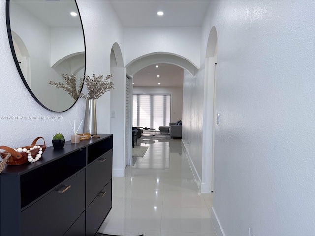 hallway featuring light tile patterned flooring, recessed lighting, and baseboards