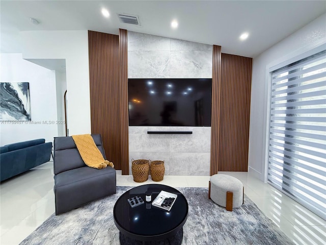 living area featuring tile patterned floors, recessed lighting, tile walls, and an accent wall