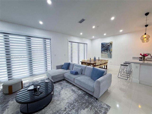 living room with recessed lighting, visible vents, and light tile patterned floors