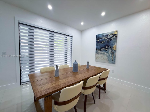 dining area featuring light tile patterned floors, recessed lighting, and baseboards