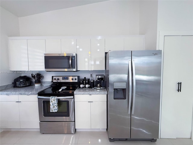 kitchen featuring stainless steel appliances, modern cabinets, white cabinets, and light countertops