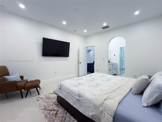 bedroom featuring recessed lighting, arched walkways, and visible vents