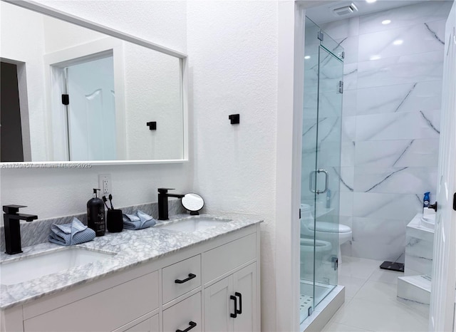 bathroom with double vanity, a shower stall, toilet, and a sink