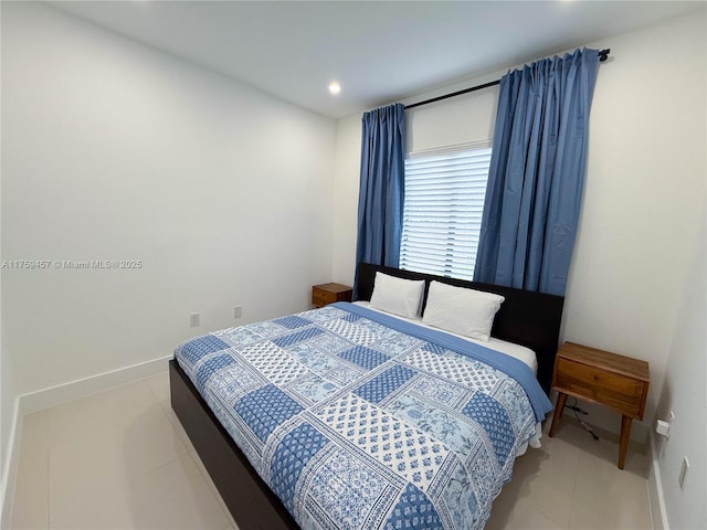 tiled bedroom featuring baseboards