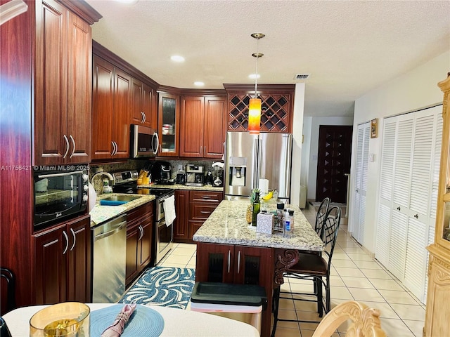 kitchen with backsplash, stainless steel appliances, visible vents, and light tile patterned floors