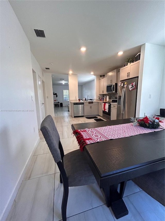 dining area with recessed lighting, baseboards, and visible vents