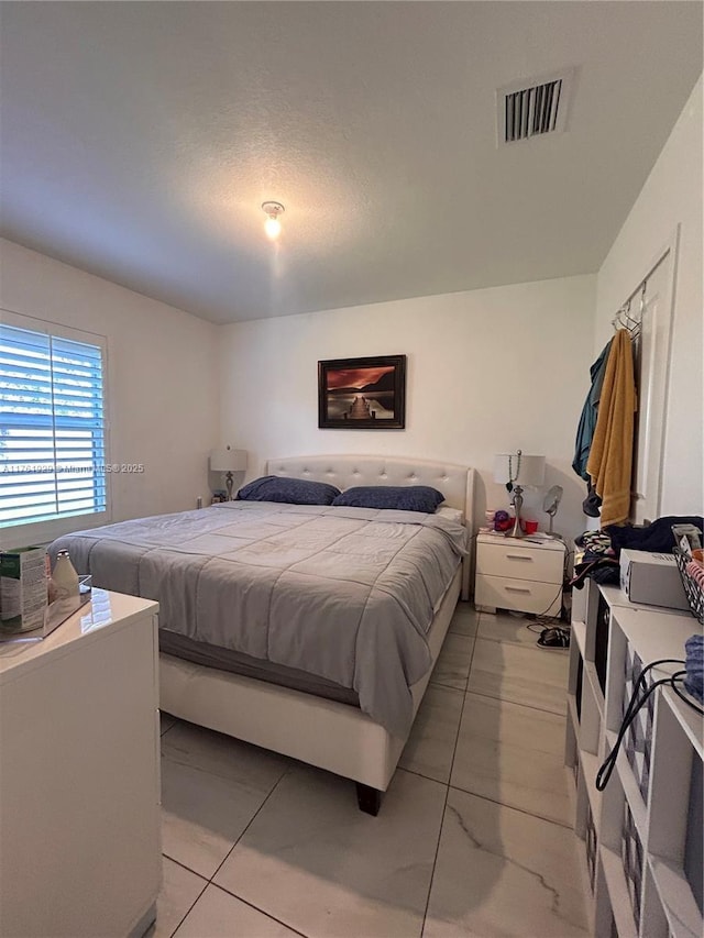 bedroom featuring visible vents