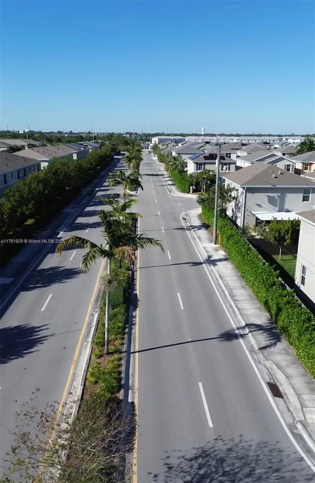 view of street with curbs and a residential view