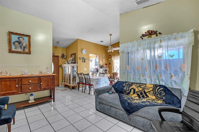 living room with lofted ceiling, light tile patterned flooring, visible vents, and a textured ceiling