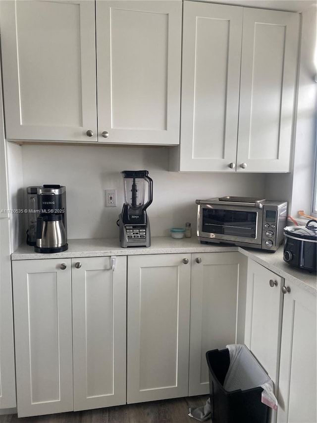 kitchen with white cabinetry, light countertops, and a toaster