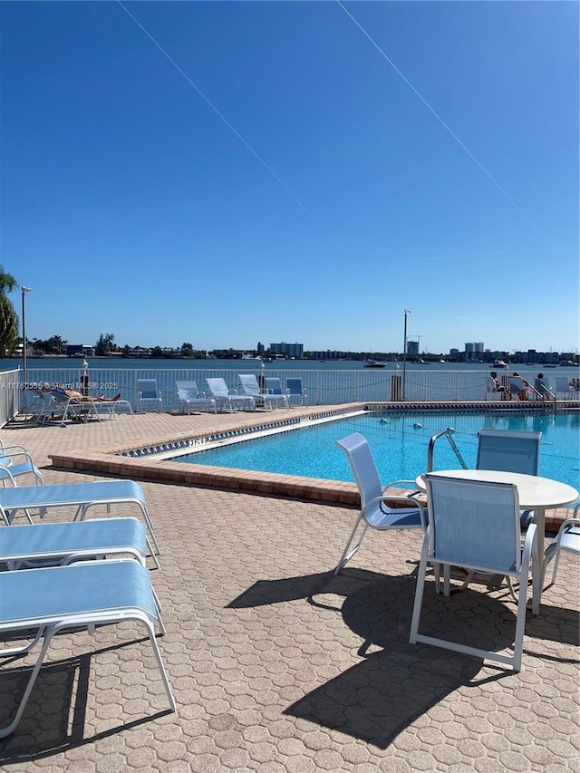 pool with a patio area and outdoor dining space