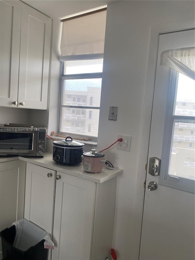 kitchen with light countertops, white cabinets, and a toaster