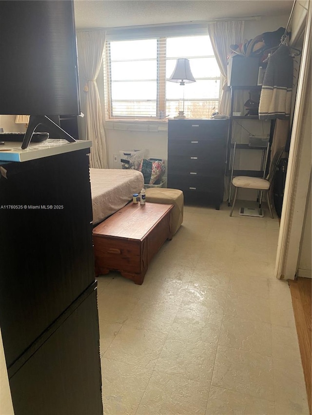 bedroom featuring light floors