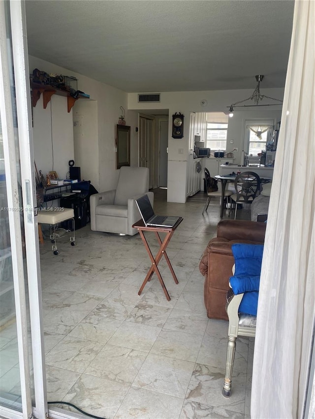 living room with visible vents and marble finish floor