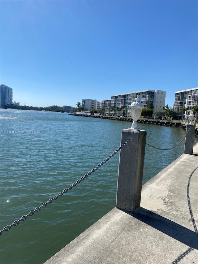 exterior space with a water view and a city view