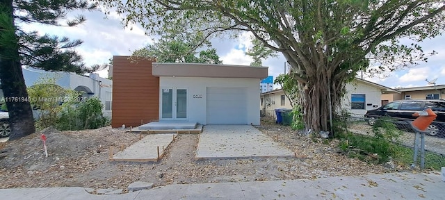 view of front of house featuring french doors, a garage, and fence