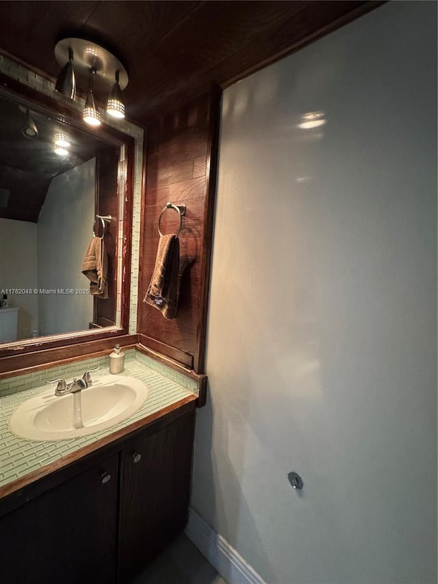 bathroom with vanity and baseboards