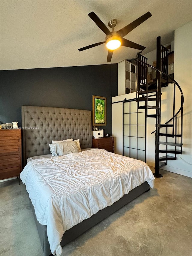 bedroom with ceiling fan, a textured ceiling, concrete floors, and lofted ceiling