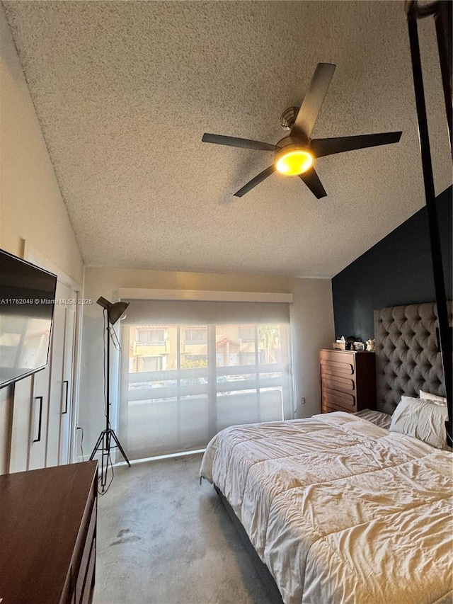 bedroom featuring ceiling fan, a textured ceiling, carpet, and lofted ceiling