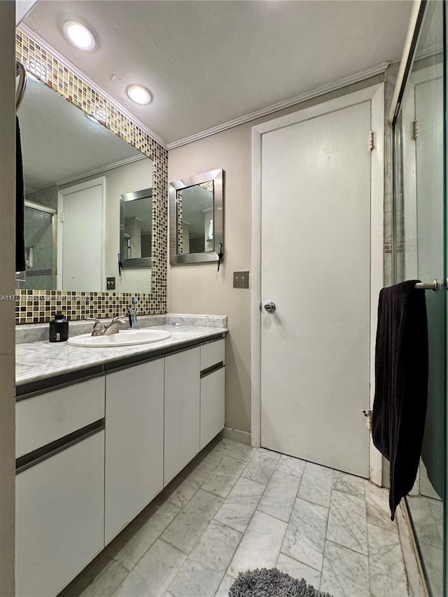 full bath with vanity, ornamental molding, a shower stall, marble finish floor, and backsplash