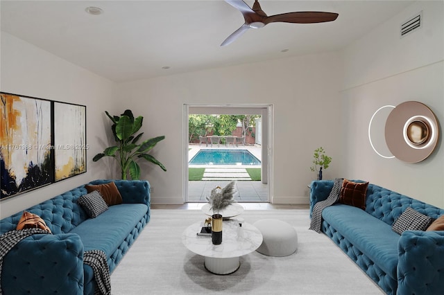 living room with a ceiling fan, baseboards, and visible vents