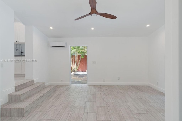 unfurnished room with recessed lighting, baseboards, a wall unit AC, and ceiling fan