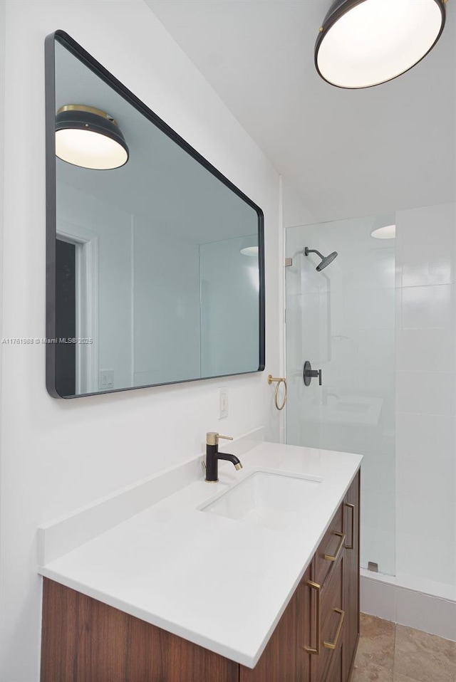 full bathroom with a shower stall and vanity