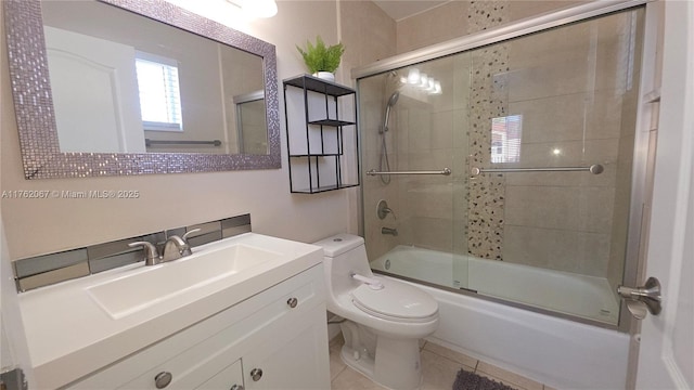 bathroom featuring tile patterned floors, toilet, vanity, and bath / shower combo with glass door