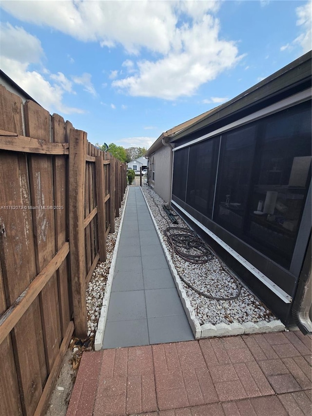 exterior space with a sunroom and fence