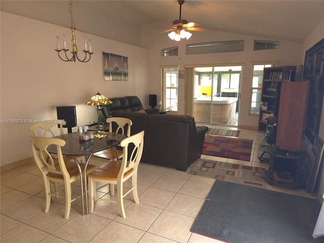 dining room featuring lofted ceiling, light tile patterned flooring, and ceiling fan with notable chandelier