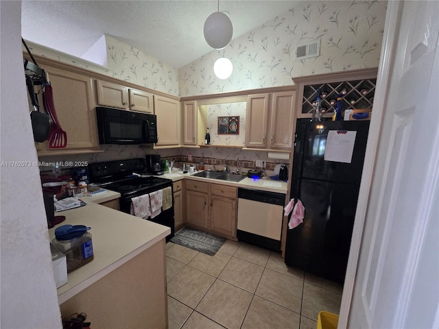 kitchen featuring visible vents, wallpapered walls, a sink, black appliances, and light countertops