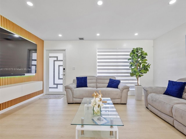 living room featuring recessed lighting, visible vents, and wood finished floors