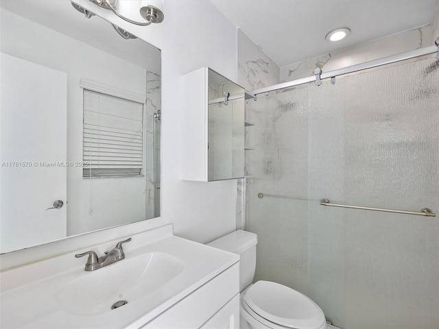 full bath featuring a shower stall, toilet, and vanity