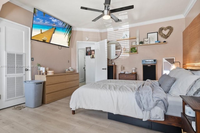 bedroom with wood finished floors, ornamental molding, and a ceiling fan