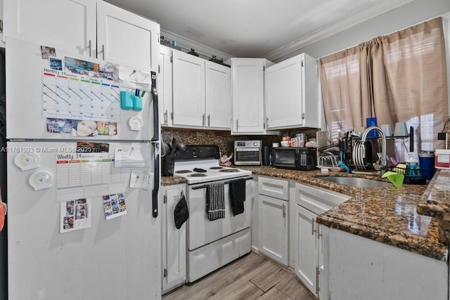 kitchen with ornamental molding, a sink, white cabinetry, white appliances, and light wood finished floors