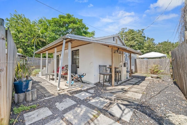 exterior space with a patio area, stucco siding, and a fenced backyard