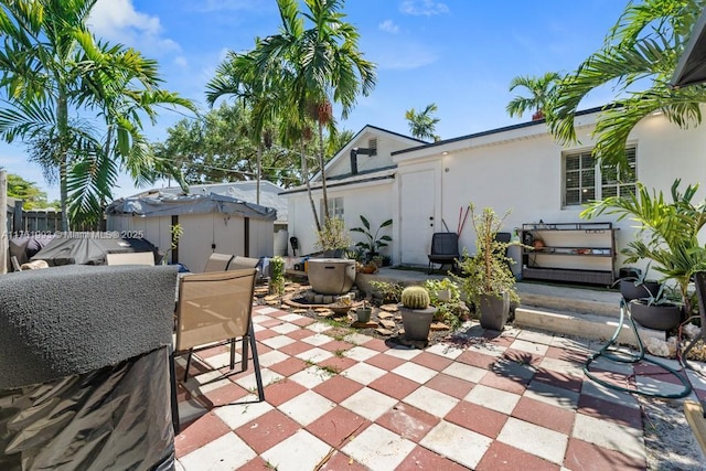 view of patio featuring an outdoor structure and fence