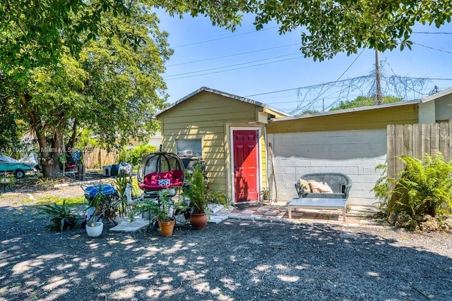 view of outbuilding featuring fence