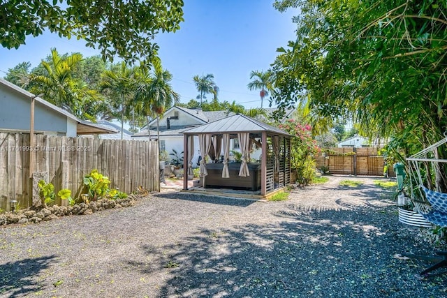 view of outdoor structure featuring fence and a hot tub