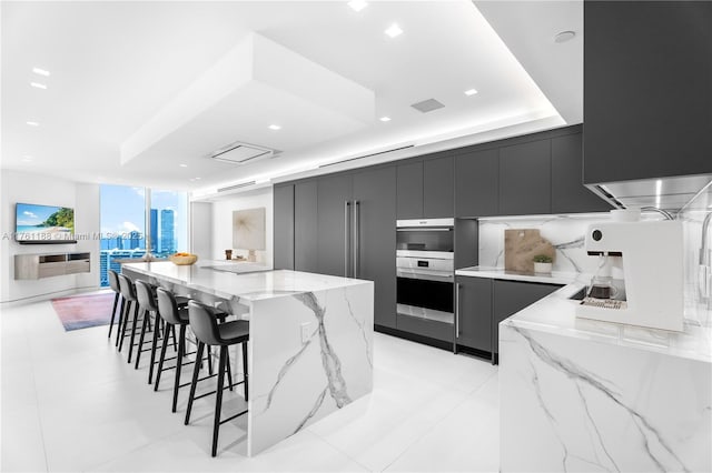 3301 NE 183rd St Unit Ph04, Aventura, FL 33160 - kitchen featuring modern cabinets, dark cabinetry, double oven, a breakfast bar area, and recessed lighting