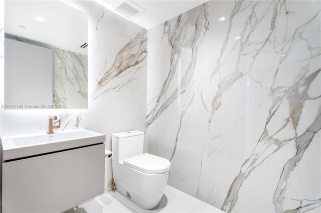 3301 NE 183rd St Unit Ph04, Aventura, FL 33160 - bathroom featuring vanity, toilet, and stone wall