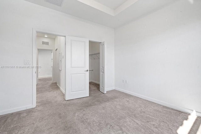 unfurnished bedroom with visible vents, carpet, and baseboards