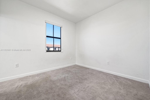 spare room with carpet flooring and baseboards