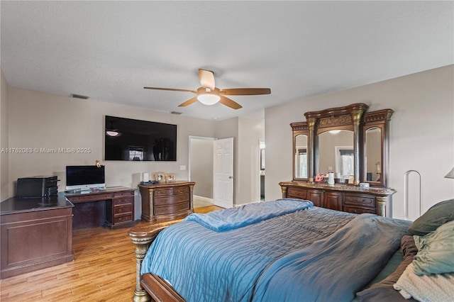 bedroom featuring ceiling fan, visible vents, and light wood-type flooring