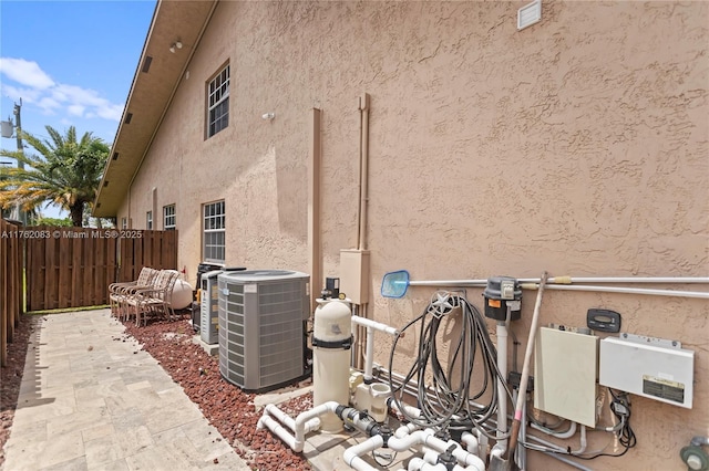 view of home's exterior featuring fence, a patio area, cooling unit, and stucco siding