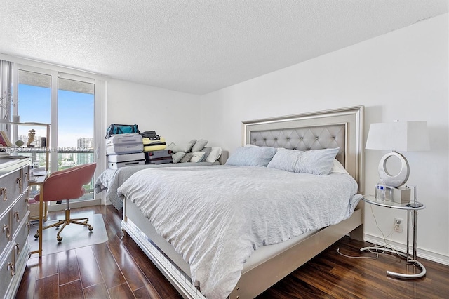 100 Bayview Dr Unit 2128, Sunny Isles Beach, FL 33160 - bedroom with dark wood-style flooring, a view of city, and a textured ceiling
