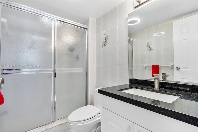 100 Bayview Dr Unit 2128, Sunny Isles Beach, FL 33160 - bathroom featuring tile walls, vanity, and a stall shower