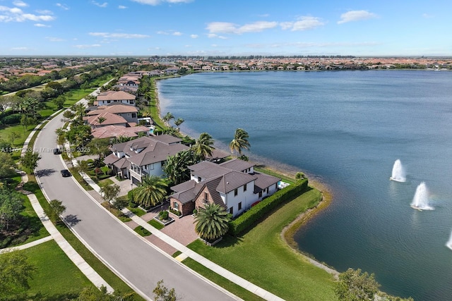 drone / aerial view featuring a residential view and a water view